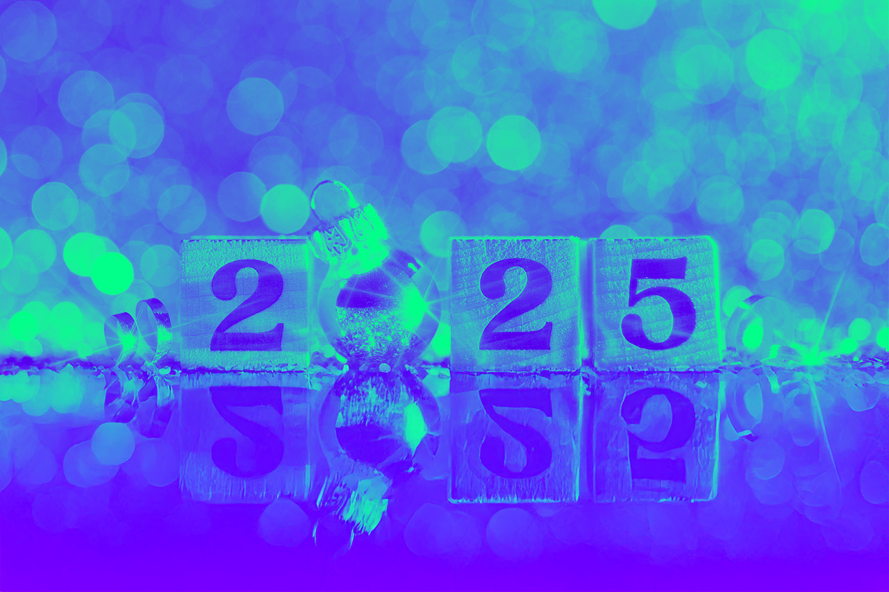 Wooden blocks displaying the year 2025, with a silver Christmas ornament replacing the zero